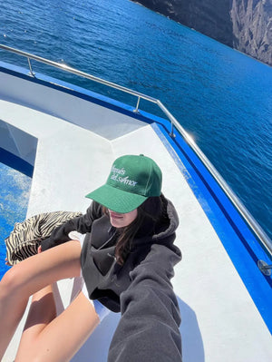 modelo con gorra verde "después del amor" en un barco